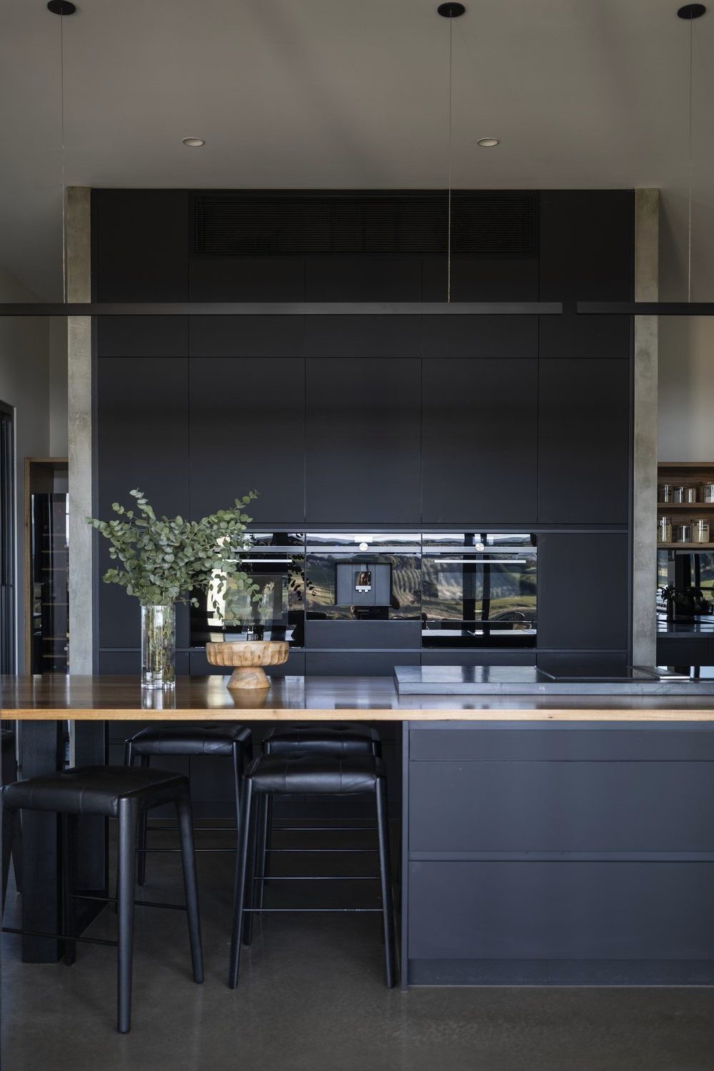 Dark kitchen with timber island